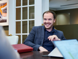 Lundy employee smiling at conference table